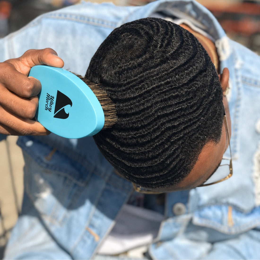 Man brushing his 360 waves with a medium wave brush during a brush session.