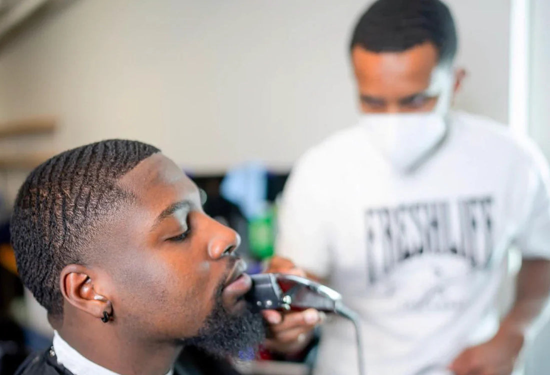 a barber cutting a waver with a 360 waves hairstyle