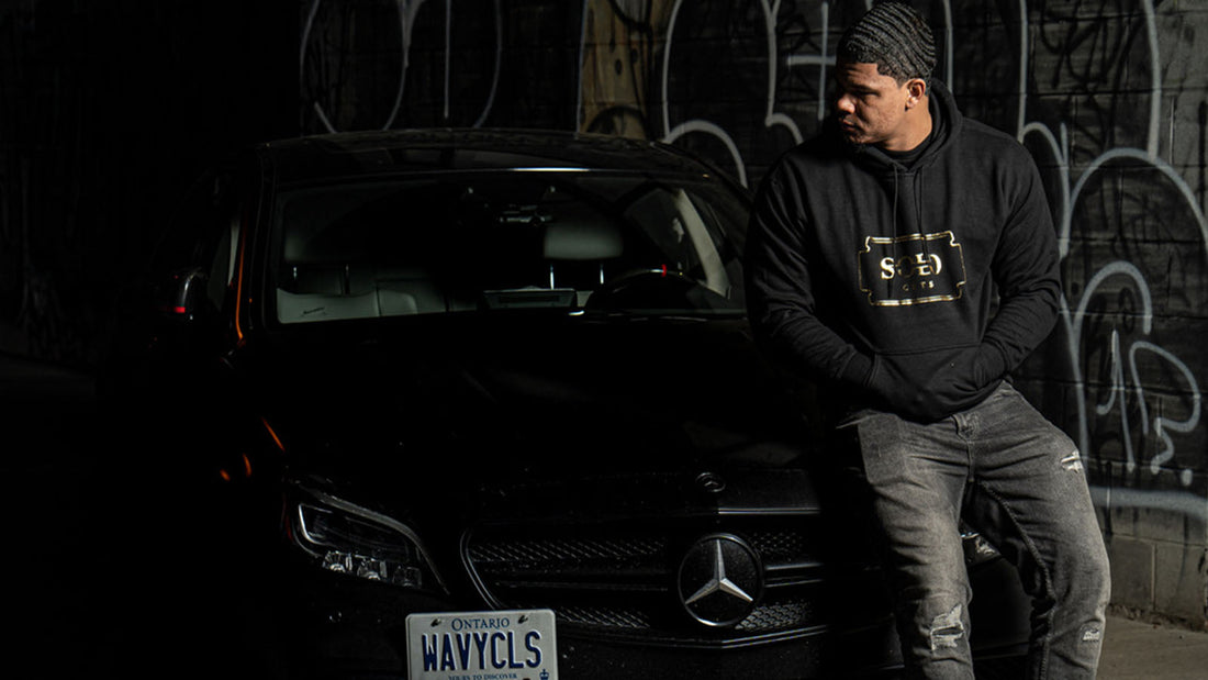 A model with deep 360 waves sitting on a Mercedes Benz