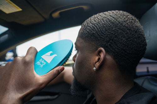 A waver holding an alaska ice medium wave brush for 360 waves